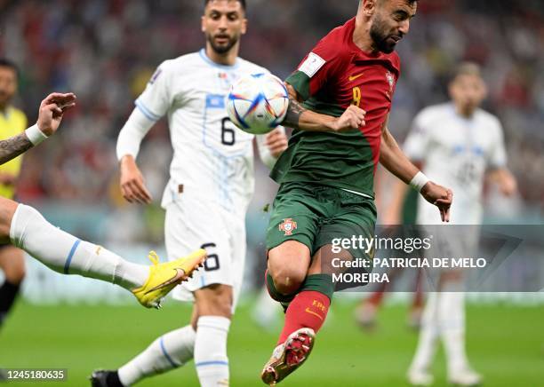 Uruguay's defender Guillermo Varela and Portugal's forward Andre Silva fight for the ball during the Qatar 2022 World Cup Group H football match...