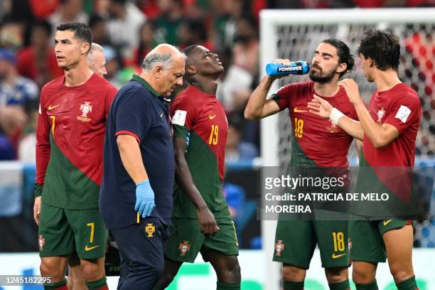 Portugal's defender Nuno Mendes reacts as he leaves the pitch after sustaining an injury during the Qatar 2022 World Cup Group H football match...