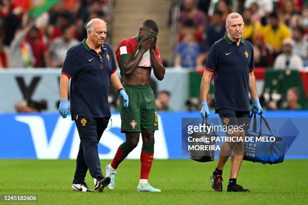 Portugal's defender Nuno Mendes reacts as he leaves the pitch after sustaining an injury during the Qatar 2022 World Cup Group H football match...