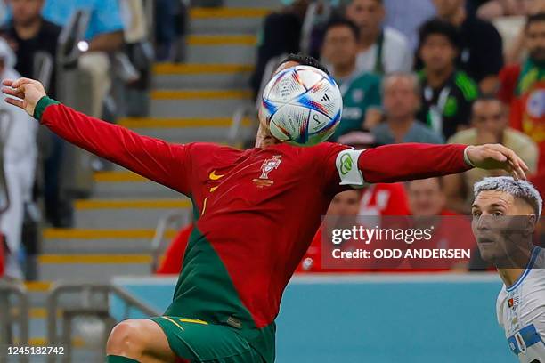 Portugal's forward Cristiano Ronaldo fights for the ball with Uruguay's defender Guillermo Varela during the Qatar 2022 World Cup Group H football...