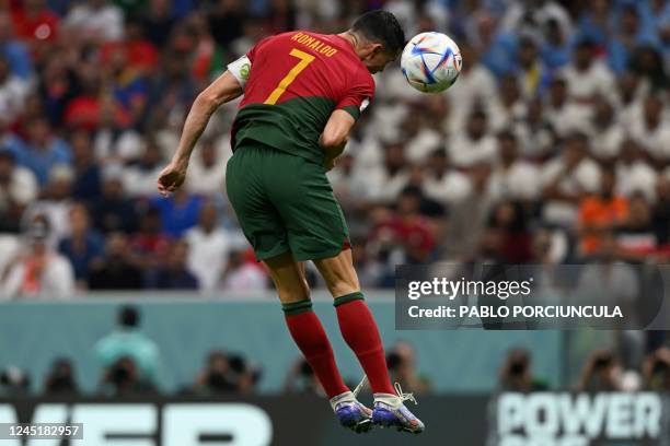 Portugal's forward Cristiano Ronaldo scores his team's first goal during the Qatar 2022 World Cup Group H football match between Portugal and Uruguay...
