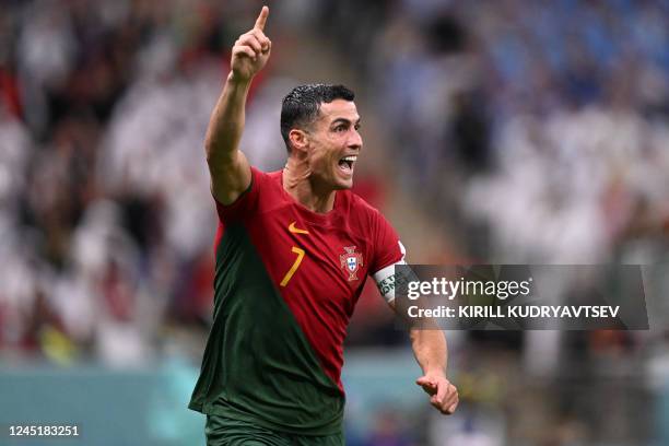 Portugal's forward Cristiano Ronaldo celebrates scoring his team's first goal during the Qatar 2022 World Cup Group H football match between Portugal...