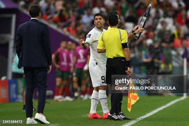 Uruguay's forward Luis Suarez talks to Uruguay's coach Diego Alonso as he prepares to enter the pitch during the Qatar 2022 World Cup Group H...