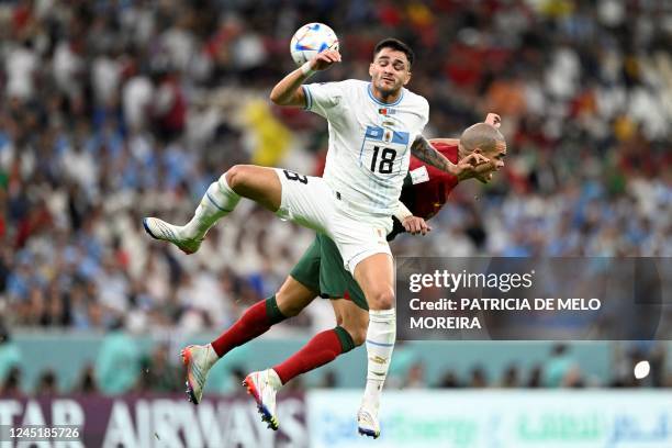 Uruguay's forward Maximiliano Gomez and Portugal's defender Pepe fight for the ball during the Qatar 2022 World Cup Group H football match between...