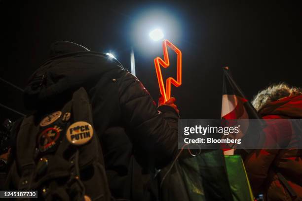 Protester holds a women's strike symbol during a demonstration against Poland's abortion law, outside the home of Law and Justice Party Leader...