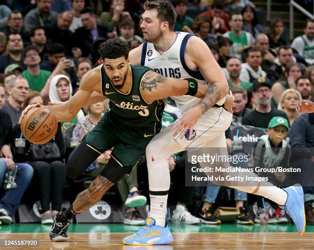 November 23: Jayson Tatum of the Boston Celtics pushes past Luka Doncic of the Dallas Mavericks during the second half of the NBA game at the TD...