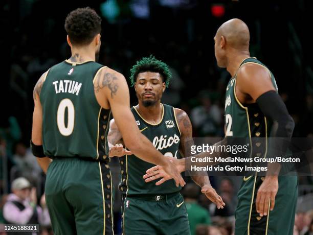 November 23: Jayson Tatum, Marcus Smart and Al Horford of the Boston Celtics celebrate during the second half of the NBA game against the Dallas...