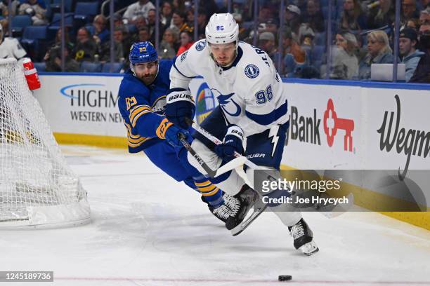 Alex Tuch of the Buffalo Sabres battles for the puck against Mikhail Sergachev of the Tampa Bay Lightning during an NHL game on November 28, 2022 at...