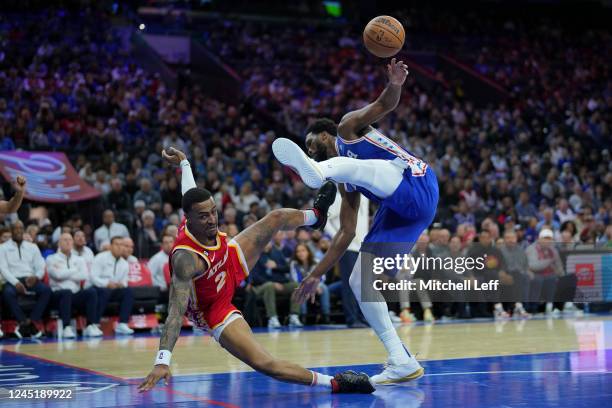 Joel Embiid of the Philadelphia 76ers fouls John Collins of the Atlanta Hawks in the fourth quarter at the Wells Fargo Center on November 28, 2022 in...
