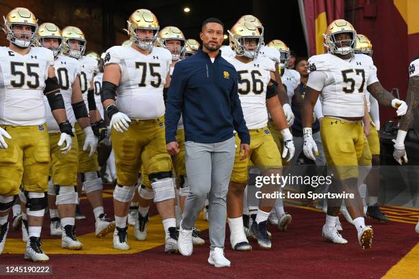 Notre Dame Fighting Irish head coach Marcus Freeman leads his team out to the field before a game between the Notre Dame Fighting Irish and the USC...