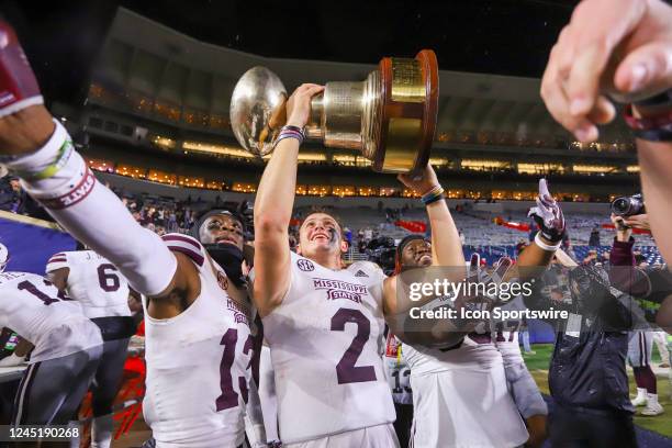 Mississippi State Bulldogs quarterback Will Rogers holds The Egg Bowl trophy after the game between the Ole Miss Rebels and the Mississippi State...