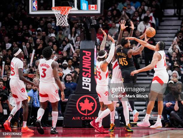 Donovan Mitchell of the Cleveland Cavaliers is guarded by Scottie Barnes, Pascal Siakam, Gary Trent Jr. #33, O.G. Anunoby and Chris Boucher of the...