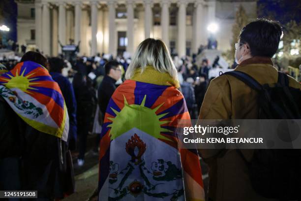 People wear Tibetan flags as people gather at Columbia University during a protest in support of demonstrations held in China calling for an end to...