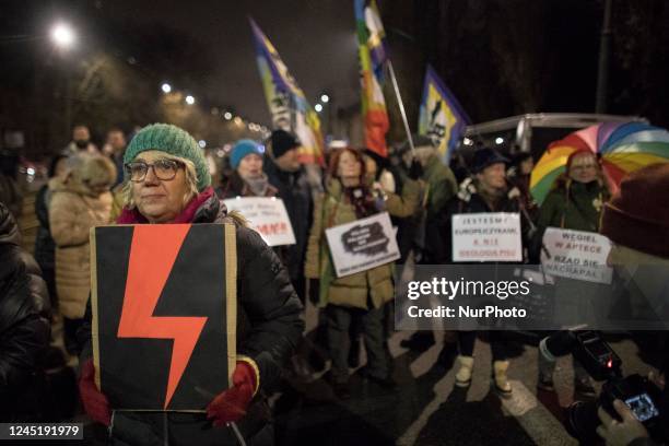 Woman holds a Red Bolt, Women's Strike symbol during protest against what they few as contempt against women and an erosion of their rights under the...