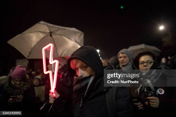 Woman holds a Red Bolt, Women's Strike symbol during protest against what they few as contempt against women and an erosion of their rights under the...