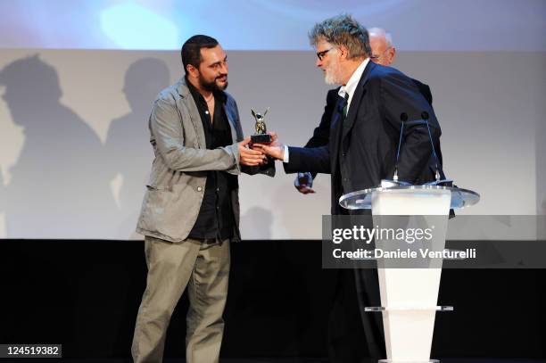 Guido Lombardi accepts The Lion of the Future for best first work for "La Bas. A Criminal Education" from Jury member Carlo Mazzacurati during the...