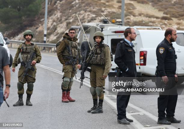 Graphic content / Israeli army soldiers and police gather at the scene of a ramming attack on an Israeli soldier, at the Mukhmas junction near the...