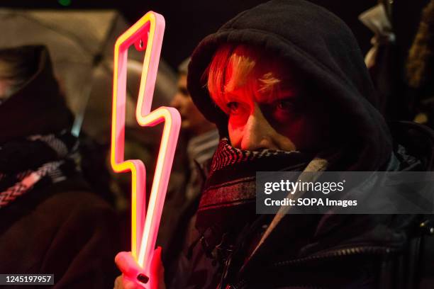 Protester holds a Lightning red bolt - the symbol of the Women's Strike during the demonstration outside Kaczynski's house in Warsaw. On the 104th...