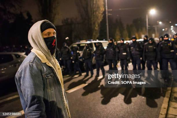 Protester wearing a mask with a red bolt is seen during the demonstration outside Kaczynski's house in Warsaw. On the 104th anniversary of women...