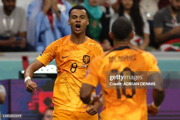 Netherlands' forward Cody Gakpo celebrates scoring his team's first goal during the Qatar 2022 World Cup Group A football match between the...