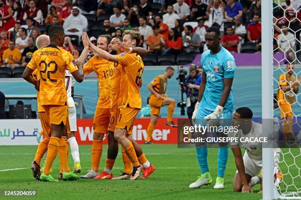 Netherlands' midfielder Frenkie De Jong celebrates scoring his team's second goal with his teammates during the Qatar 2022 World Cup Group A football...