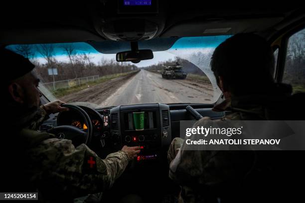 This photograph taken on November 28 shows volunteer medics from PDMSh evacuating a wounded Ukrainian soldier from a stabilizing mobile hospital in...