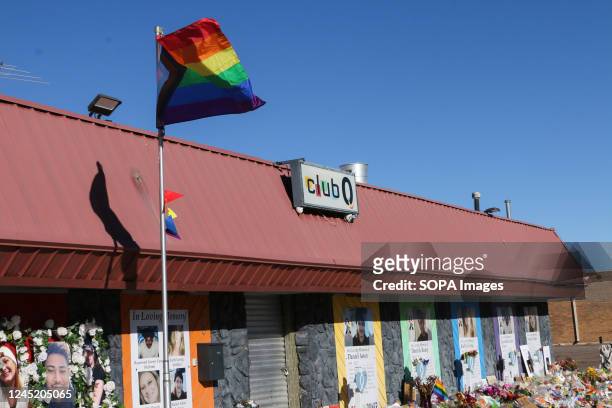 Pride flag billows in the wind as mourners visit the site of a deadly mass shooting at Club Q. The Club Q shooting memorial continues growing one...