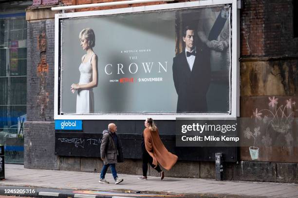 People passing billboard posters for the Netflix television series The Crown in Waterloo on 17th November 2022 in London, United Kingdom. The Crown...