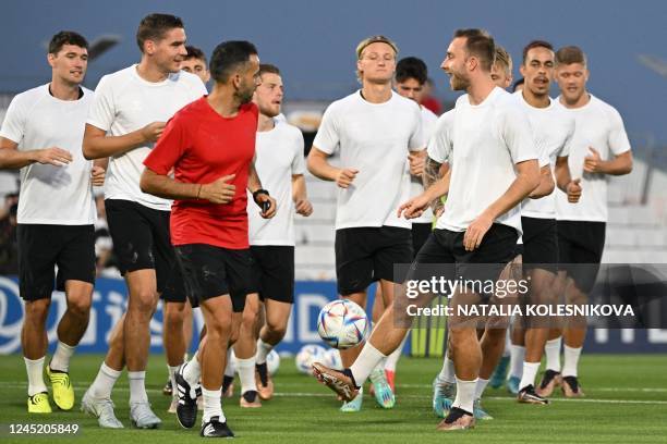 Denmark's midfielder Christian Eriksen and teammates take part in a training session at the Al Sailiya SC training site in Doha on November 29 on the...