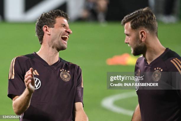 Germany's forward Thomas Mueller and Germany's forward Niclas Fuellkrug take part in a training session at the Al Shamal Stadium in Al Shamal, north...