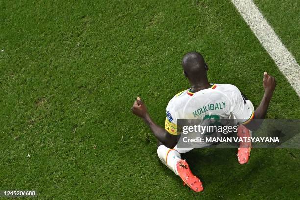 Senegal's defender Kalidou Koulibaly celebrates scoring his team's second goal during the Qatar 2022 World Cup Group A football match between Ecuador...