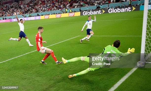 England's Phil Foden scores their second goal past Wales' Danny Ward during the FIFA World Cup Qatar 2022 Group B match between Wales and England at...