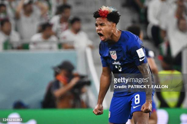 S midfielder Weston McKennie celebrates his team's first goal scored by USA's forward Christian Pulisic during the Qatar 2022 World Cup Group B...