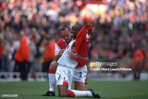 September 1997 - FA Carling Premiership - Arsenal v Bolton Wanderers - Lee Dixon of Arsenal points at teammate Ian Wright's celebratory shirt as he...