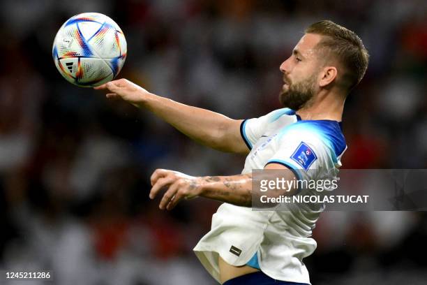 England's defender Luke Shaw jumps for the ball during the Qatar 2022 World Cup Group B football match between Wales and England at the Ahmad Bin Ali...
