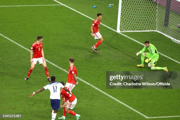 Marcus Rashford of England sees his shot squirm under Wales goalkeeper Danny Ward for the third England goal during the FIFA World Cup Qatar 2022...