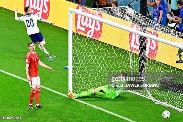 England's forward Phil Foden celebrates scoring his team's second goal past Wales' goalkeeper Danny Ward during the Qatar 2022 World Cup Group B...