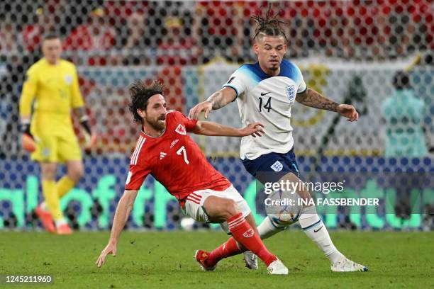 Wales' midfielder Joe Allen fights for the ball with England's midfielder Kalvin Phillips during the Qatar 2022 World Cup Group B football match...