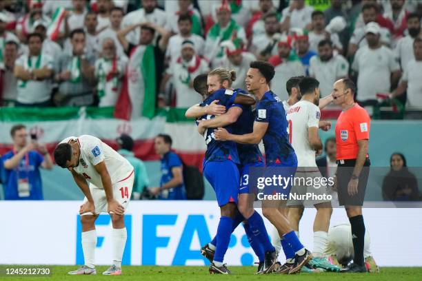 Players celebrate victory and Iran players dejected after the FIFA World Cup Qatar 2022 Group B match between IR Iran and USA at Al Thumama Stadium...