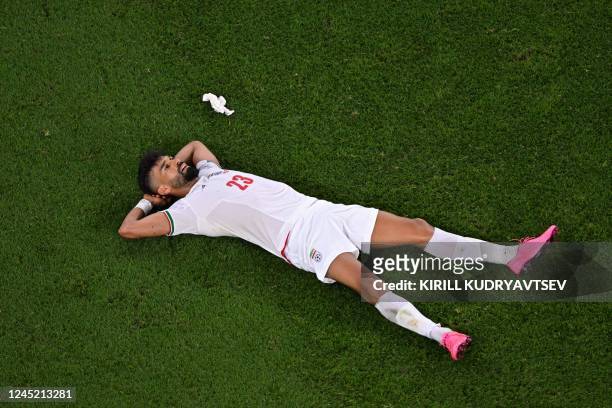Iran's defender Ramin Rezaeian reacts after the Qatar 2022 World Cup Group B football match between Iran and USA at the Al-Thumama Stadium in Doha on...