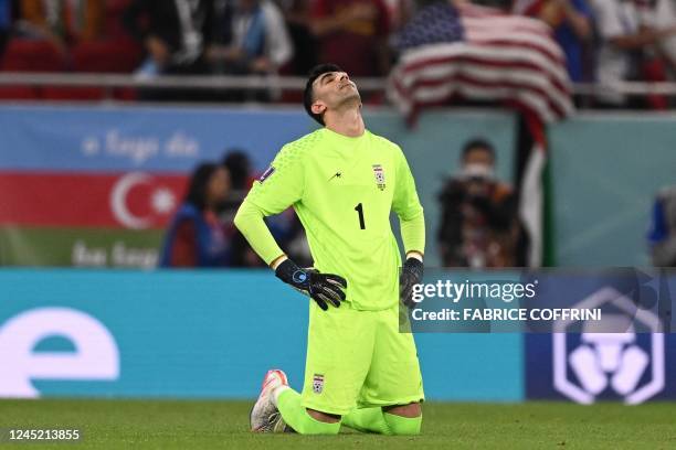 Iran's goalkeeper Alireza Beiranvand reacts at the end of the Qatar 2022 World Cup Group B football match between Iran and USA at the Al-Thumama...