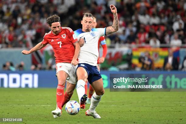 Wales' midfielder Joe Allen fights for the ball with England's midfielder Kalvin Phillips during the Qatar 2022 World Cup Group B football match...