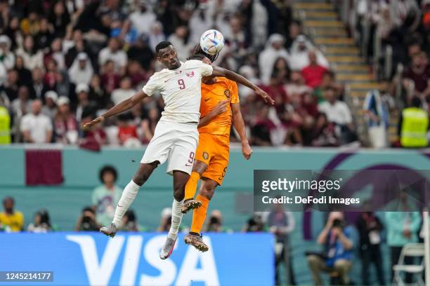 Mohammed Muntari of Qatar and Luuk de Jong of Netherlands battle for the ball during the FIFA World Cup Qatar 2022 Group A match between Netherlands...