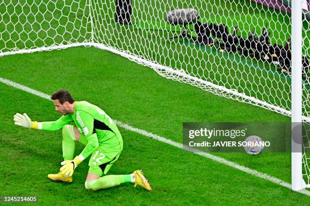 Wales' goalkeeper Danny Ward concedes England's third goal scored by England's forward Marcus Rashford during the Qatar 2022 World Cup Group B...