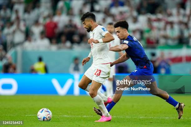 Ramin Rezaeian right-back of Iran and Sepahan FC and Antonee Robinson left-back of USA and Fulham FC compete for the ball during the FIFA World Cup...