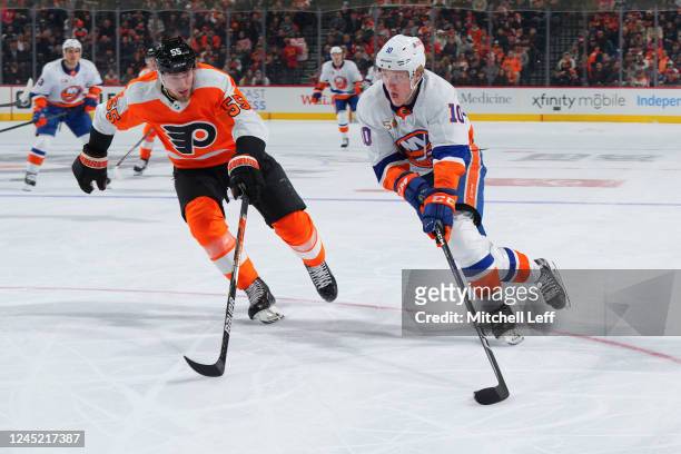 Simon Holmstrom of the New York Islanders controls the puck against Rasmus Ristolainen of the Philadelphia Flyers in the first period at the Wells...