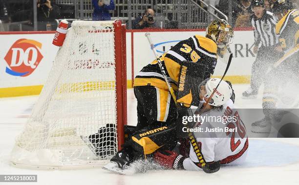 Sebastian Aho of the Carolina Hurricanes collides with Tristan Jarry of the Pittsburgh Penguins in the second period during the game at PPG PAINTS...