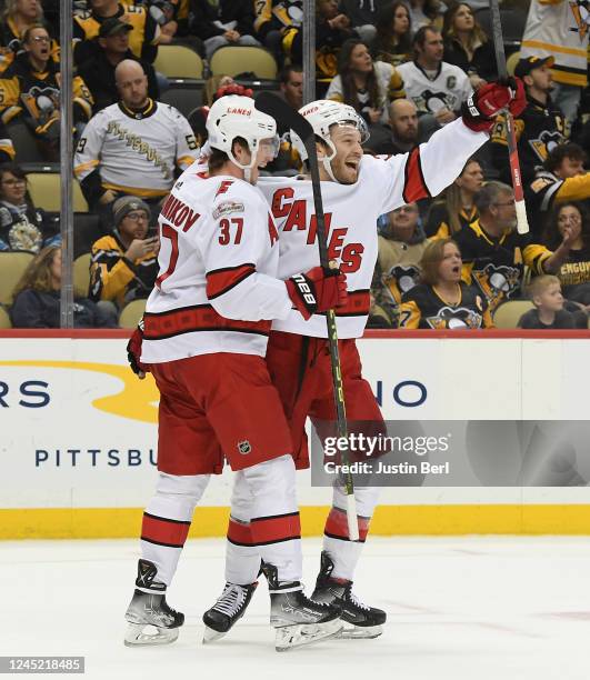 Brett Pesce of the Carolina Hurricanes celebrates with Andrei Svechnikov after scoring the overtime game winning goal past Tristan Jarry of the...