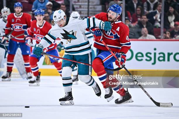 Alexander Barabanov of the San Jose Sharks and Joel Edmundson of the Montreal Canadiens skate after the puck during the third period at Centre Bell...