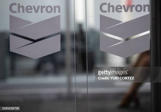 Chevron Global Technology Services Company logos are seen at an administrative office in Caracas on November 29, 2022. - The US government's...